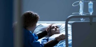 Ivermectin Hype Meets Cold Reality Patient in hospital bed with visitor holding their hand