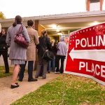 Voters standing in line outside a polling place