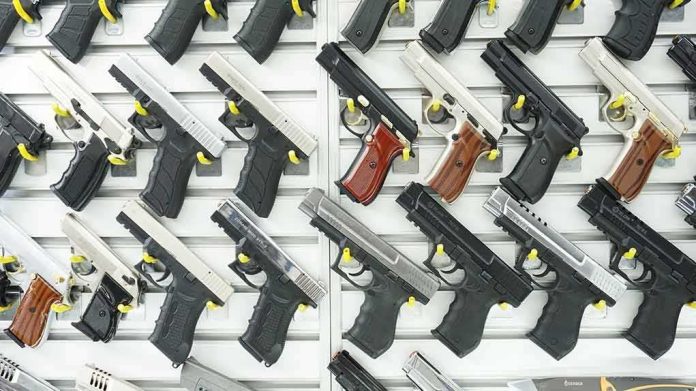 shutterstock_1096565816 Wall display of handguns in a gun store