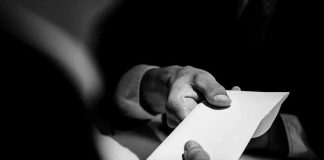 Quincy Shock: He Mailed ‘Anthrax’… With His Name Hands exchanging a white envelope