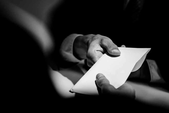 Hands exchanging a white envelope