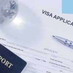 Visa application form with passport and pen