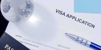 Visa application form with passport and pen
