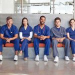Group of medical professionals sitting on a bench