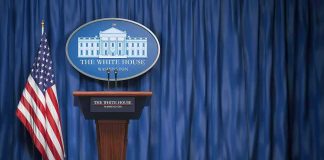 Whirlwind Firing Rumors Rattle DC White House press briefing podium with U.S. flag and blue curtain