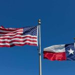 Mysterious Gap Upends Texas Race American and Texas flags waving on flagpoles
