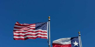 Mysterious Gap Upends Texas Race American and Texas flags waving on flagpoles
