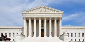 Rare Justice Alito Interviews Ignite Court Drama Front view of the Supreme Court building with large columns and steps under a blue sky