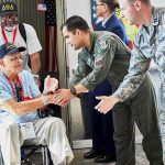 Meta’s Wild Giveaway Stuns Veterans Veteran in wheelchair greeted by military personnel at event