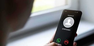 Grand Jury Drops Cyberstalking Hammer Person holding smartphone with unknown caller screen