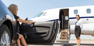 Woman stepping from luxury car toward private jet with attendant
