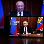 Putin Releases American Hostage man giving televised speech on smartphone screen