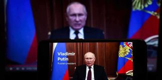 man giving televised speech on smartphone screen
