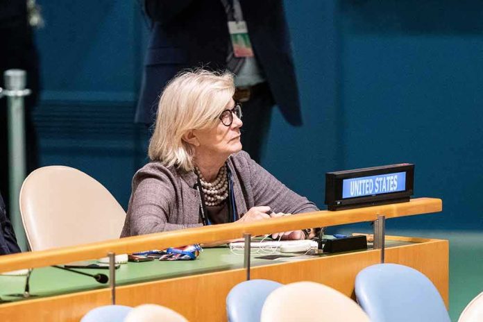 shutterstock_2204855303 Woman seated at a United Nations desk with a United States nameplate