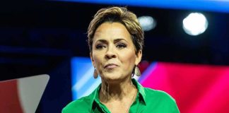 Drunk Confession Ignites Indiana Firestorm Woman speaking on stage in a green shirt