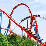 Six Flags Stunner: Safety System Under Fire Colorful roller coaster with riders on a sunny day