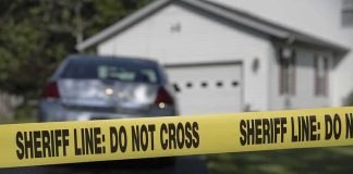 Dead Man’s Home, Officer Inside Sheriff line tape blocking a suburban driveway